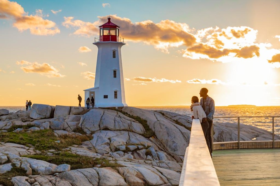 A couple embracing during sunset at Peggy's Cove.